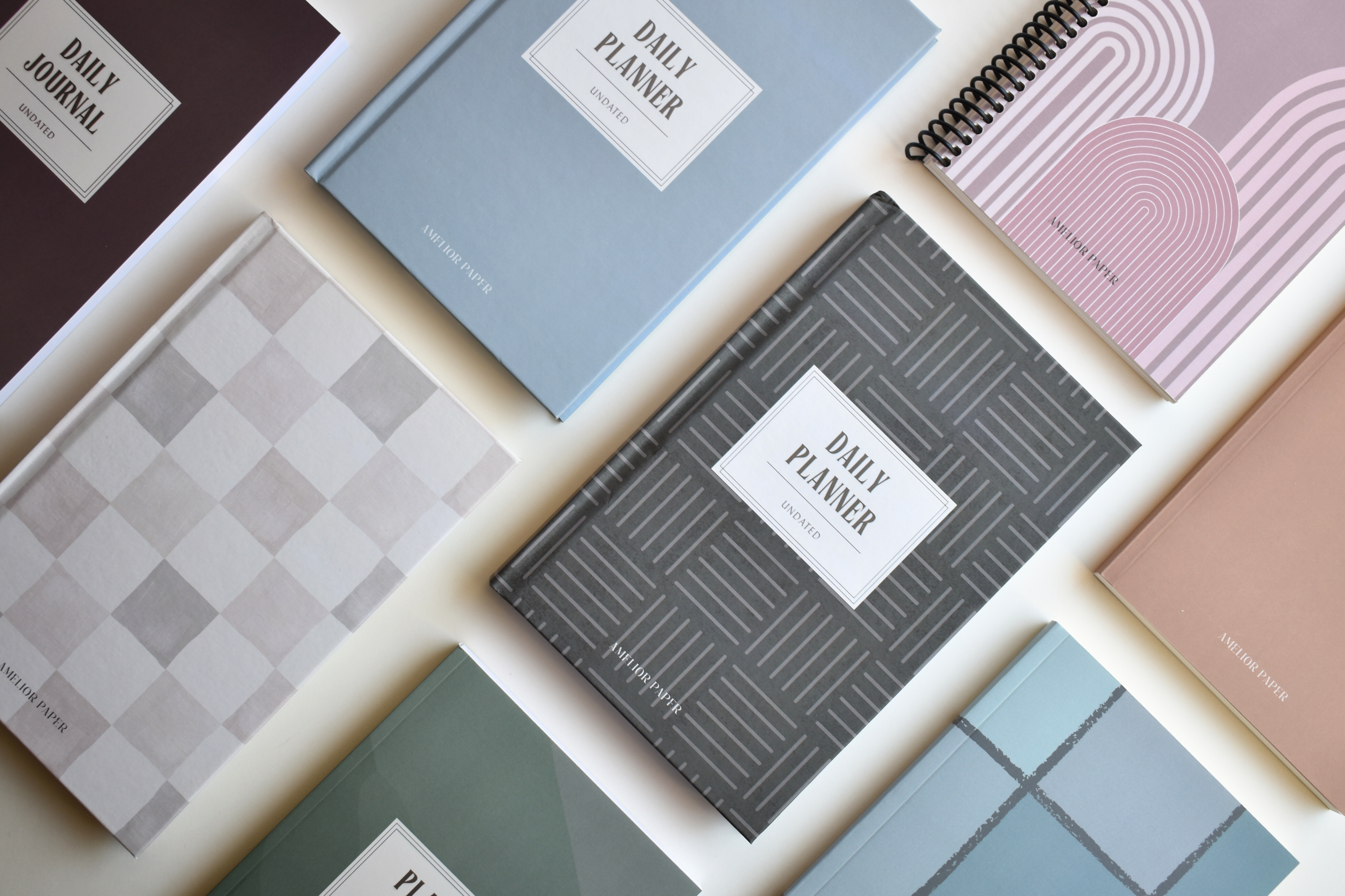 Collection of custom planners and journals with various designs on a white background